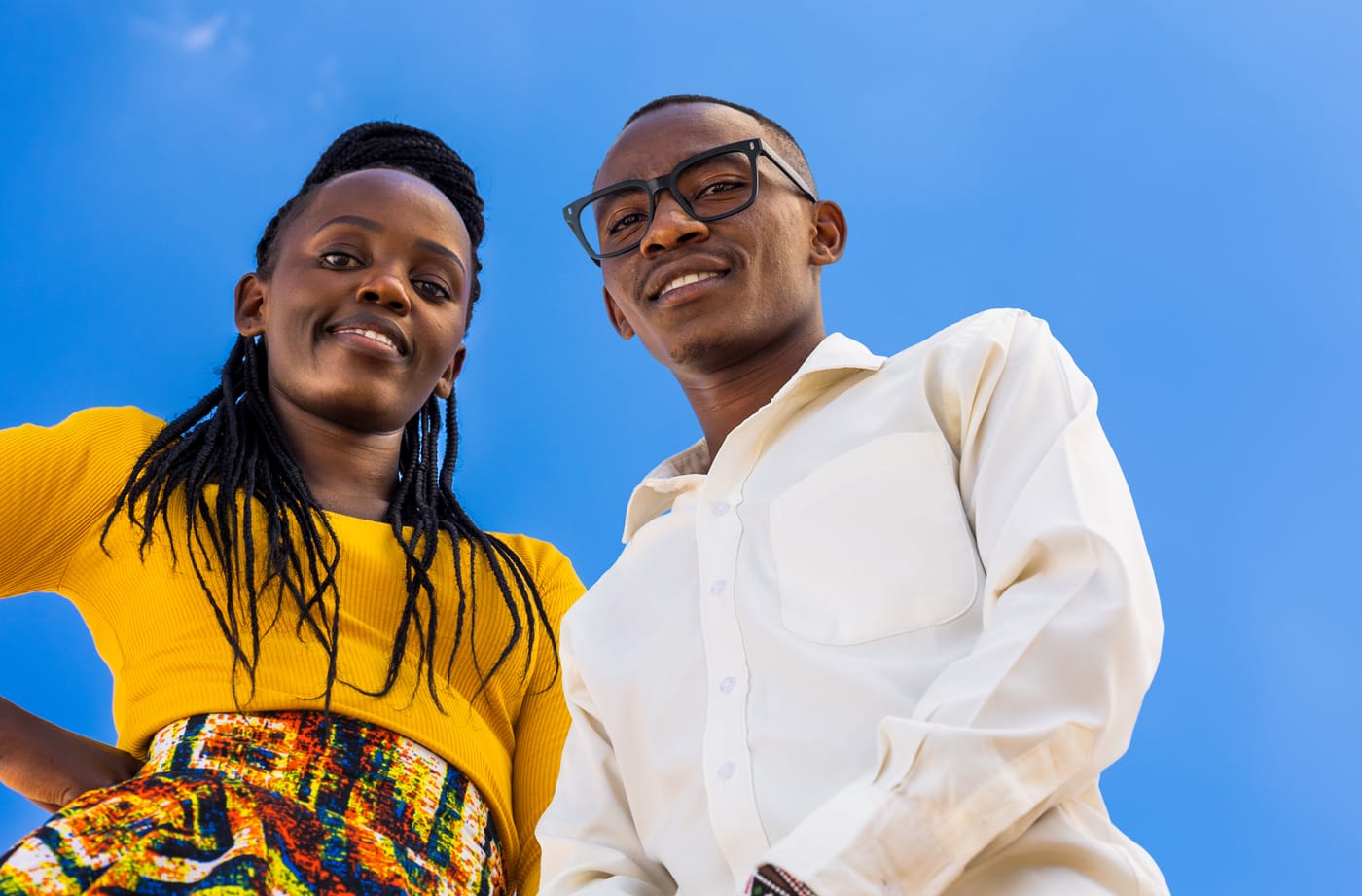 Man and woman smiling and looking down