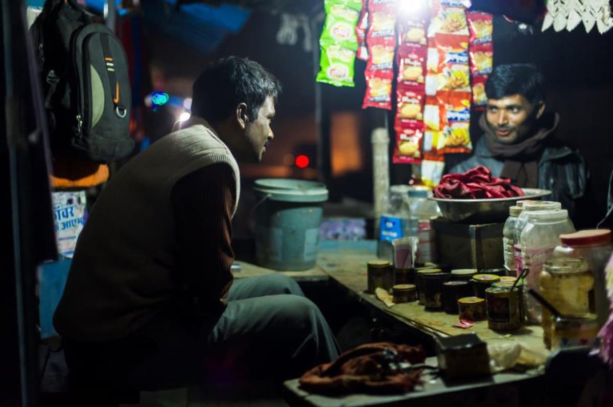Two men talking in a small store