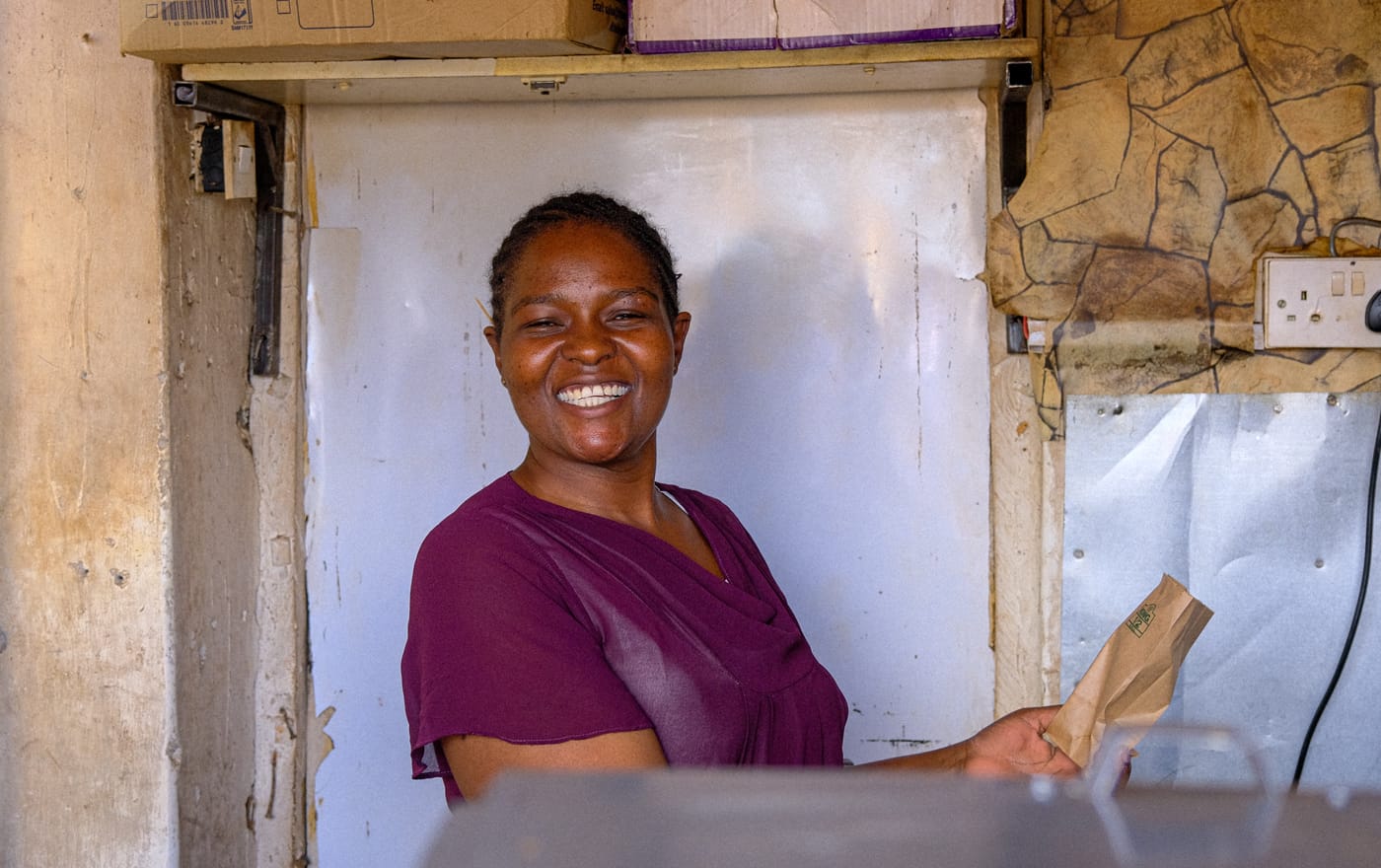 Portrait of a smiling woman holding a paper bag